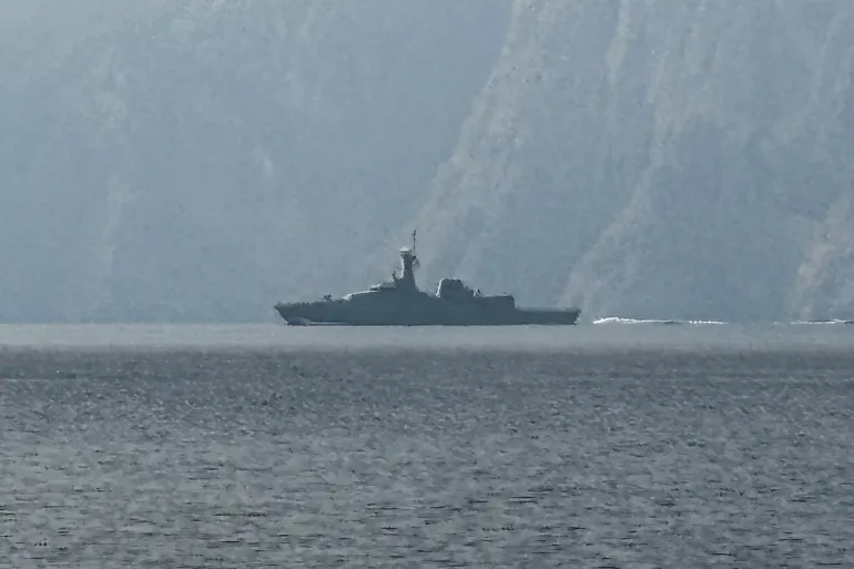 Navy vessel sailing in the Strait of Hormuz during regional maritime activity.